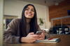 Young woman on phone in wood paneled room